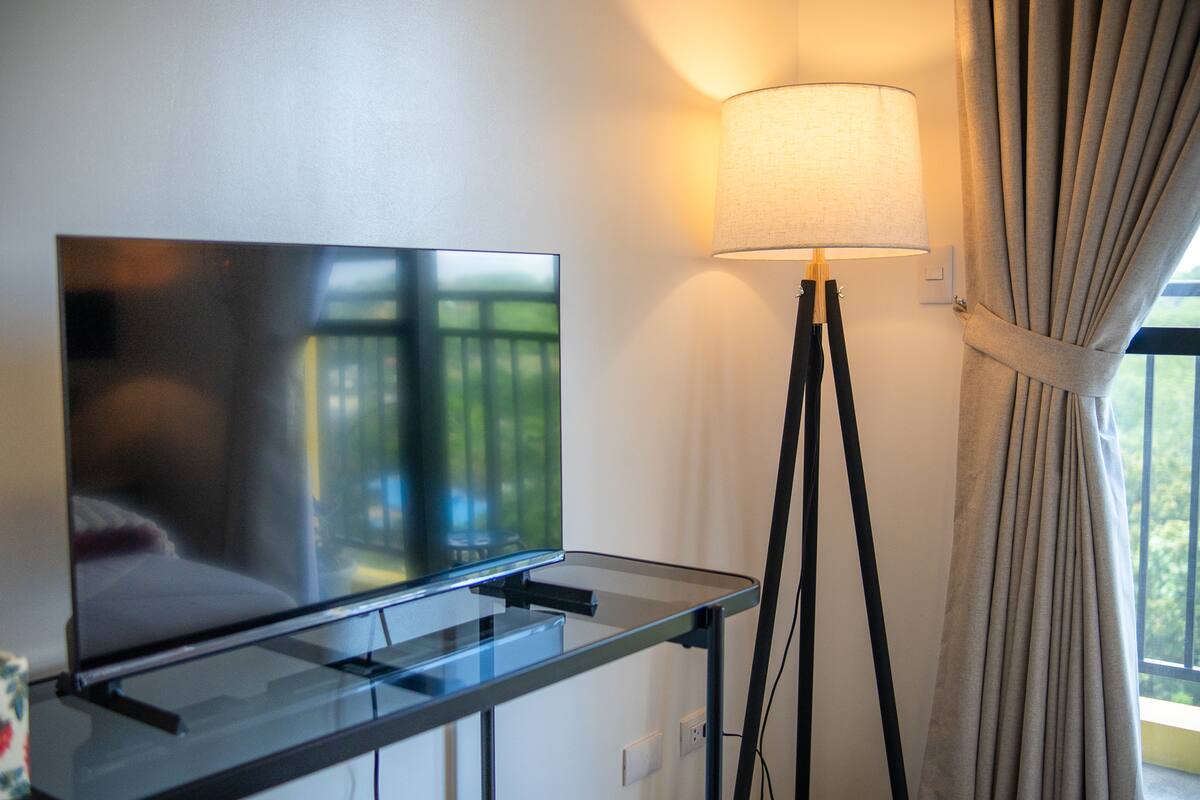Warmly lit living area with balcony view at the Davao City unit
