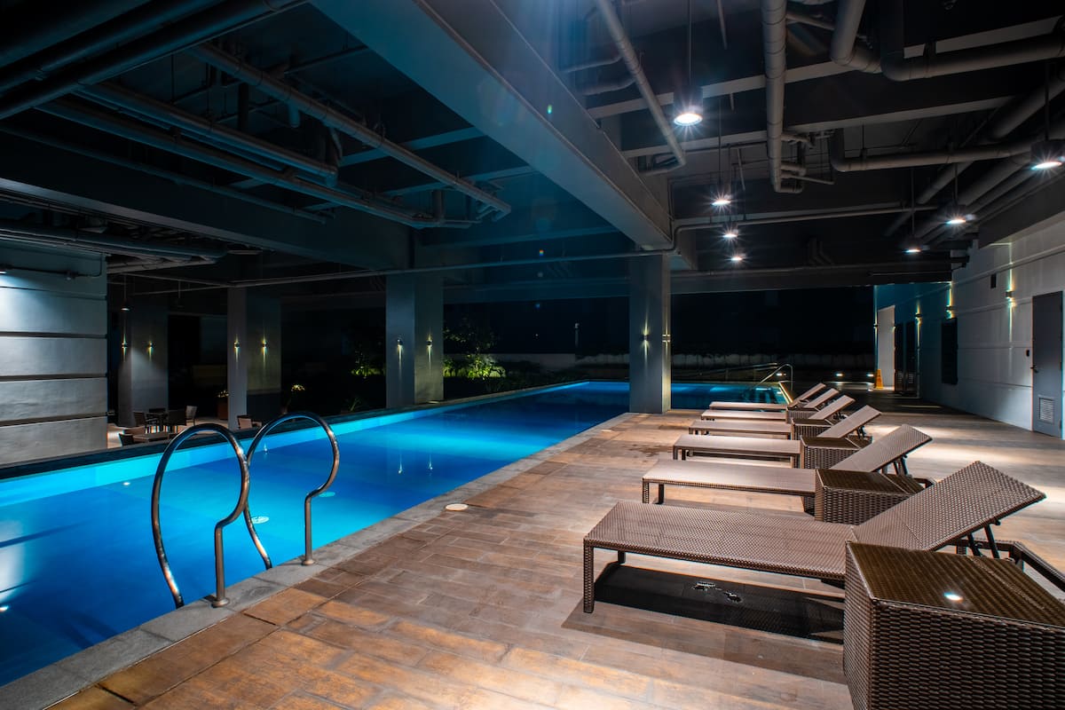 Indoor lap pool at a FlexStay-managed property, lit at night
